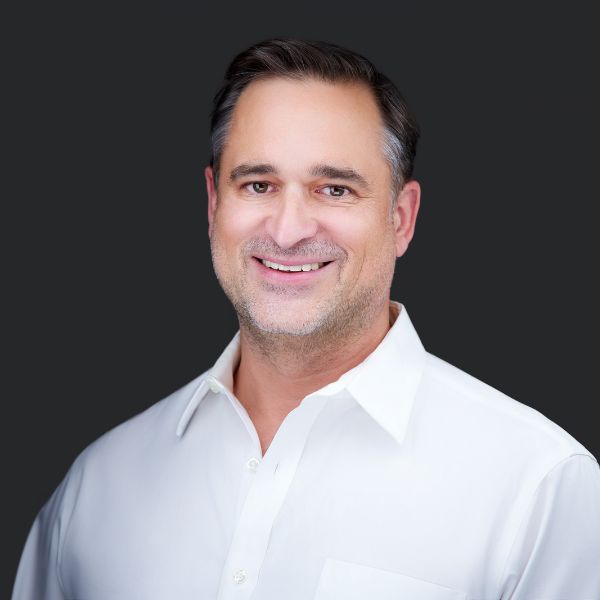 JG_Headshot_2024_whiteshirt_dark_bg_600x600